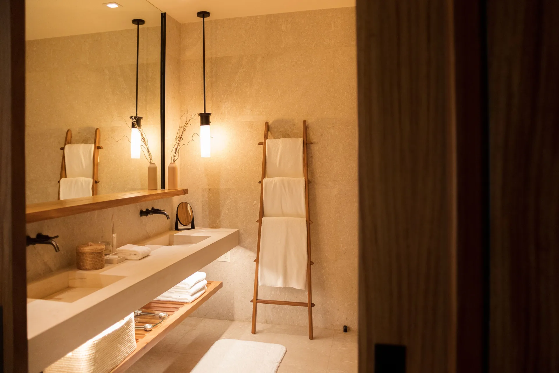 Junior Room bathroom vanity with mirrors, sinks, and towel ladder at Nobu Hotel Los Cabos.