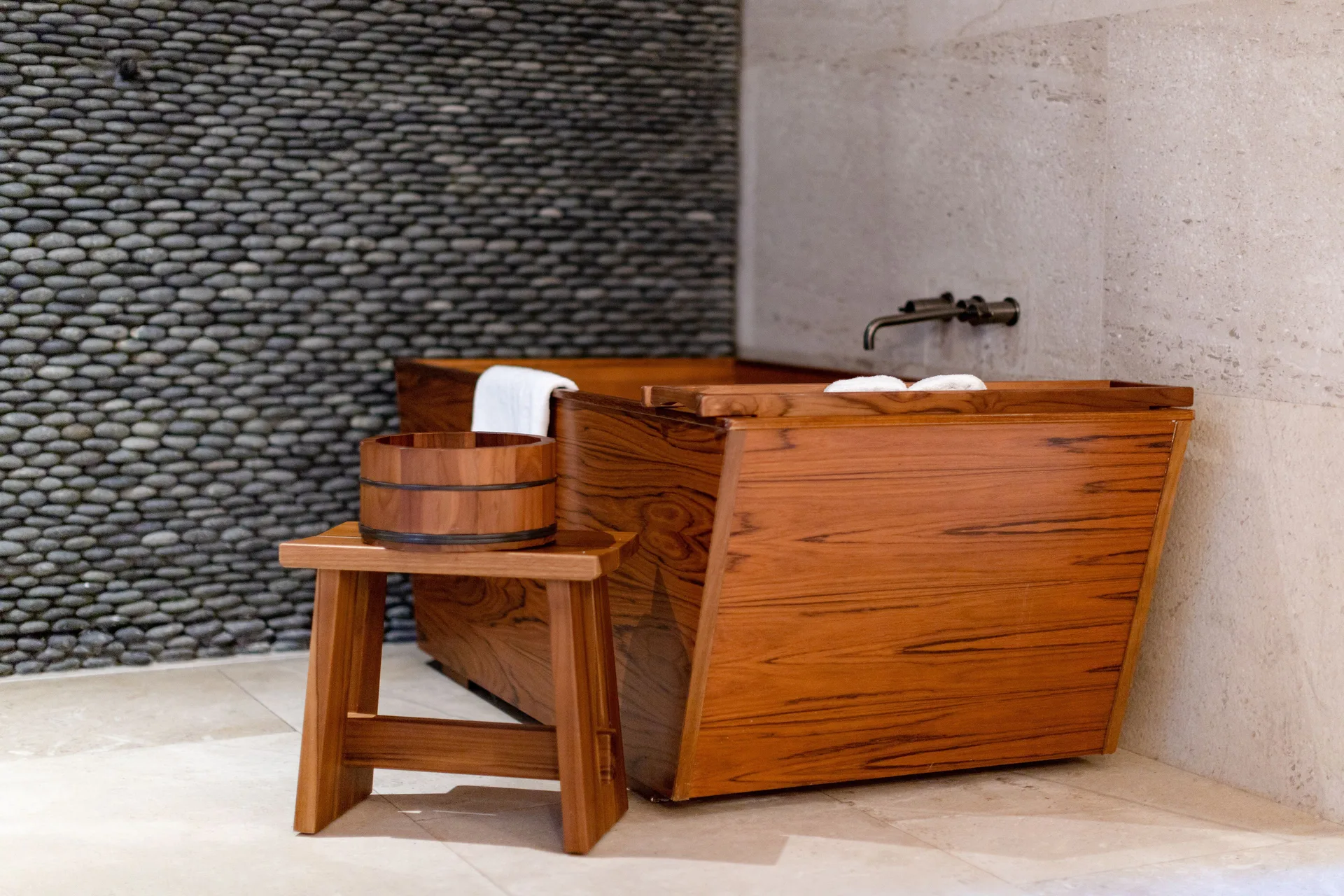 Junior Room bathroom wooden soaking tub with stool and bucket at Nobu Hotel Los Cabos.