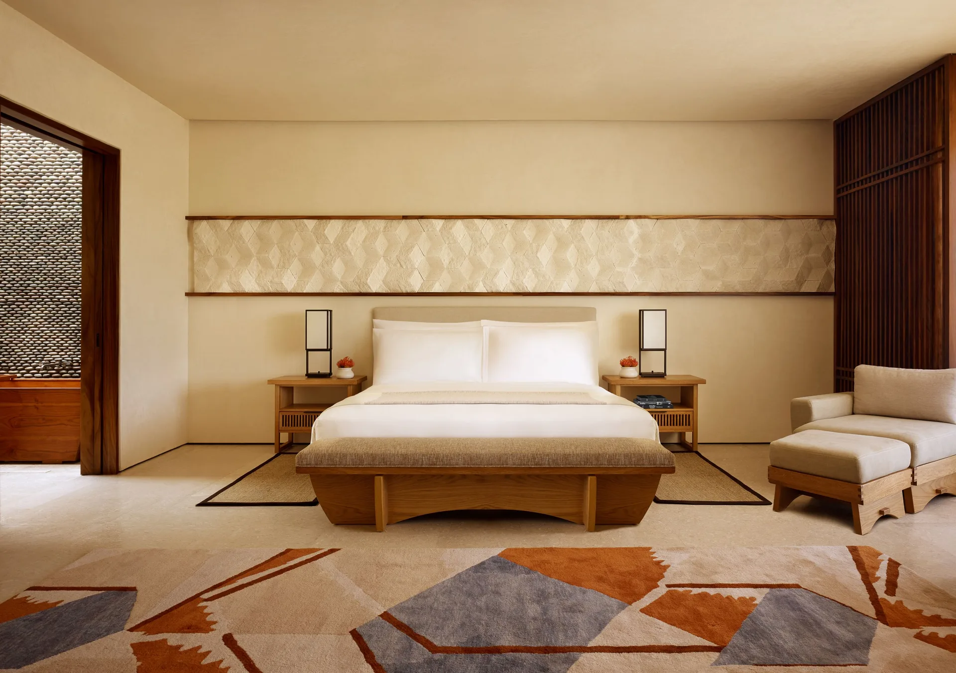 Junior Room king bed with bench and lounge chair at Nobu Hotel Los Cabos.