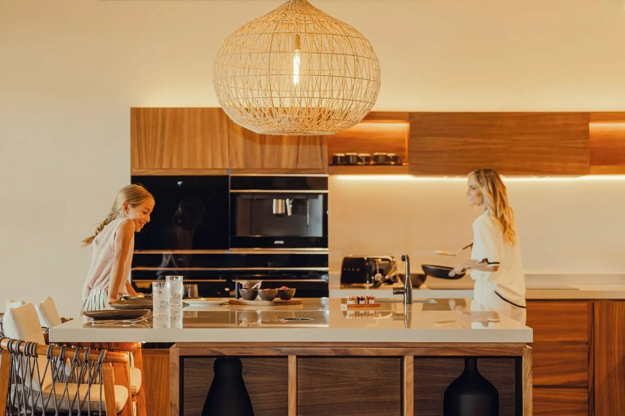 Kogane Penthouse kitchen island with guests preparing food at Nobu Hotel Los Cabos.