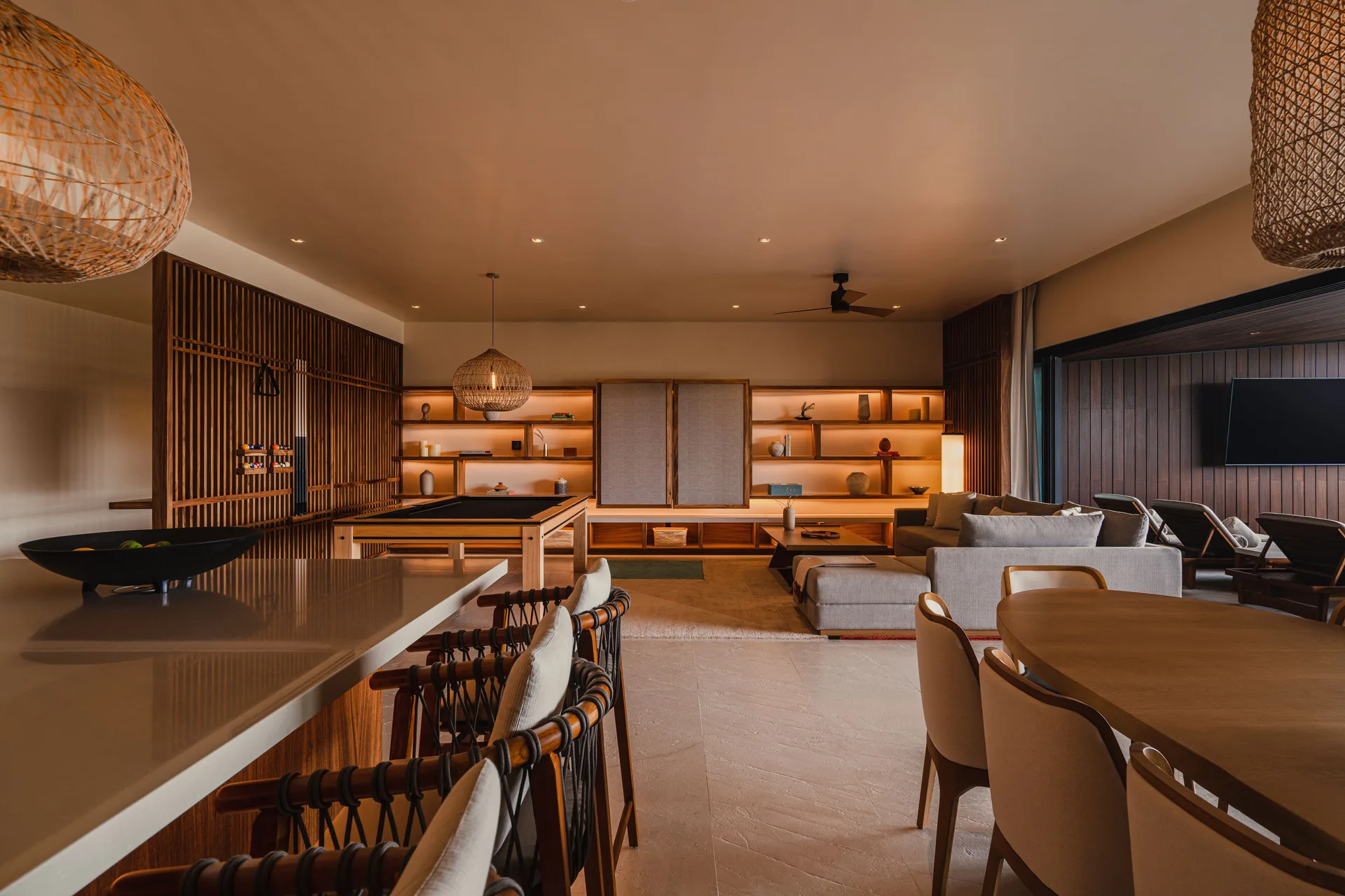 Kogane Penthouse open living room with kitchen, dining table, and lounge at Nobu Hotel Los Cabos.