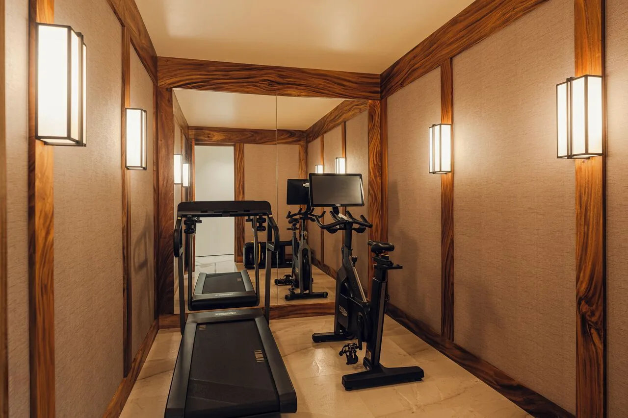 Private fitness room with treadmill and bikes in Kogane Penthouse at Nobu Hotel Los Cabos.