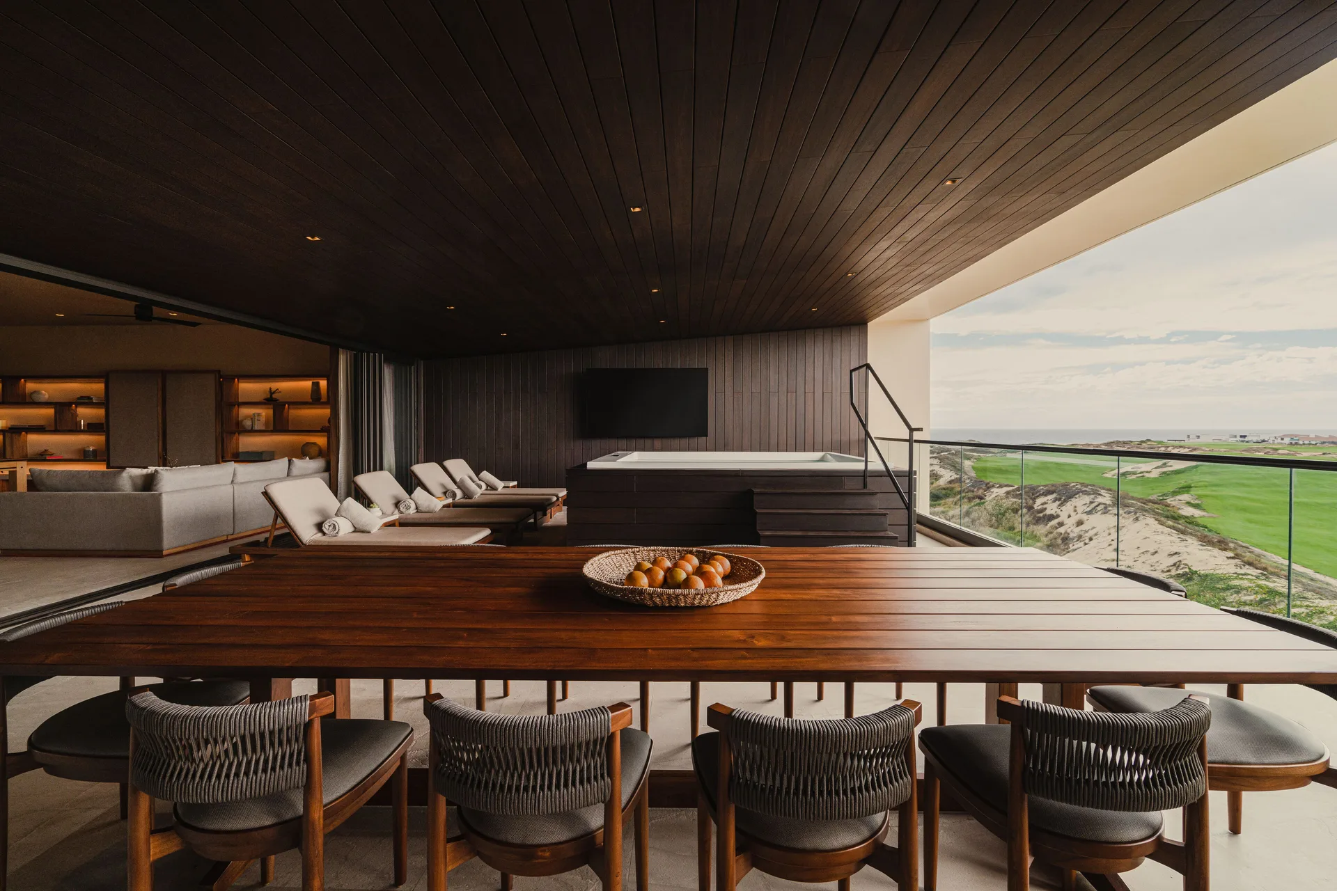 Kogane Penthouse terrace with dining table, loungers, and spa tub at Nobu Hotel Los Cabos.