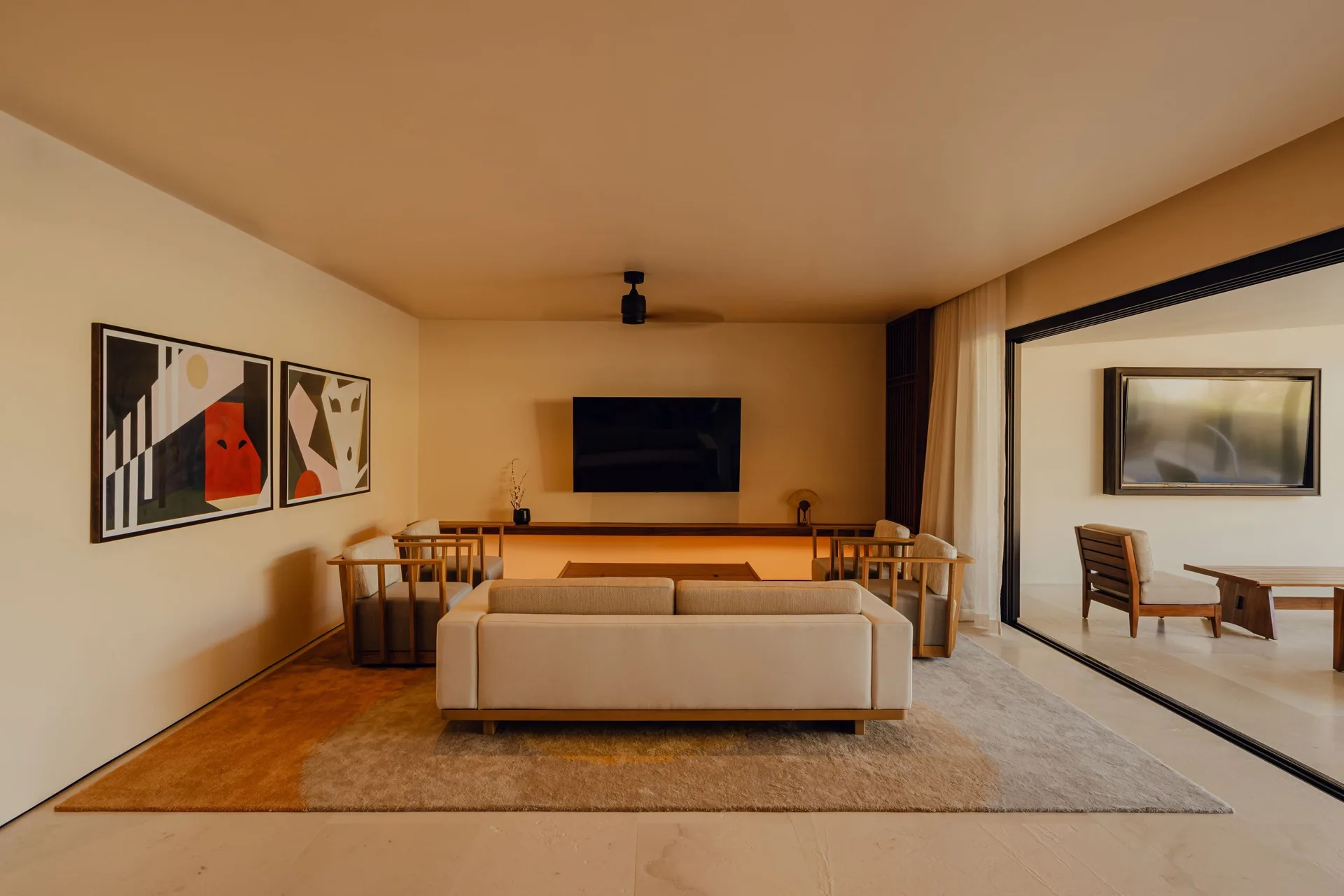 Sakyu 3 Bedrooms lounge with sofa, TV, and terrace opening at Nobu Hotel Los Cabos.