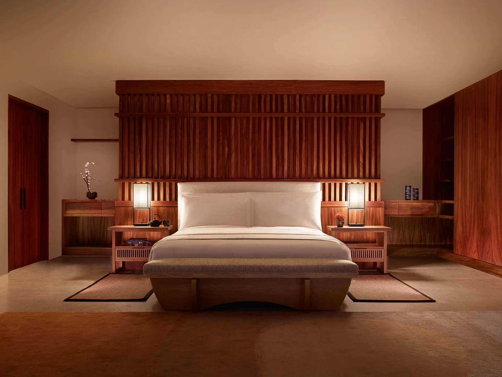Suite Ocean View king bed with warm wood headboard at Nobu Hotel Los Cabos.