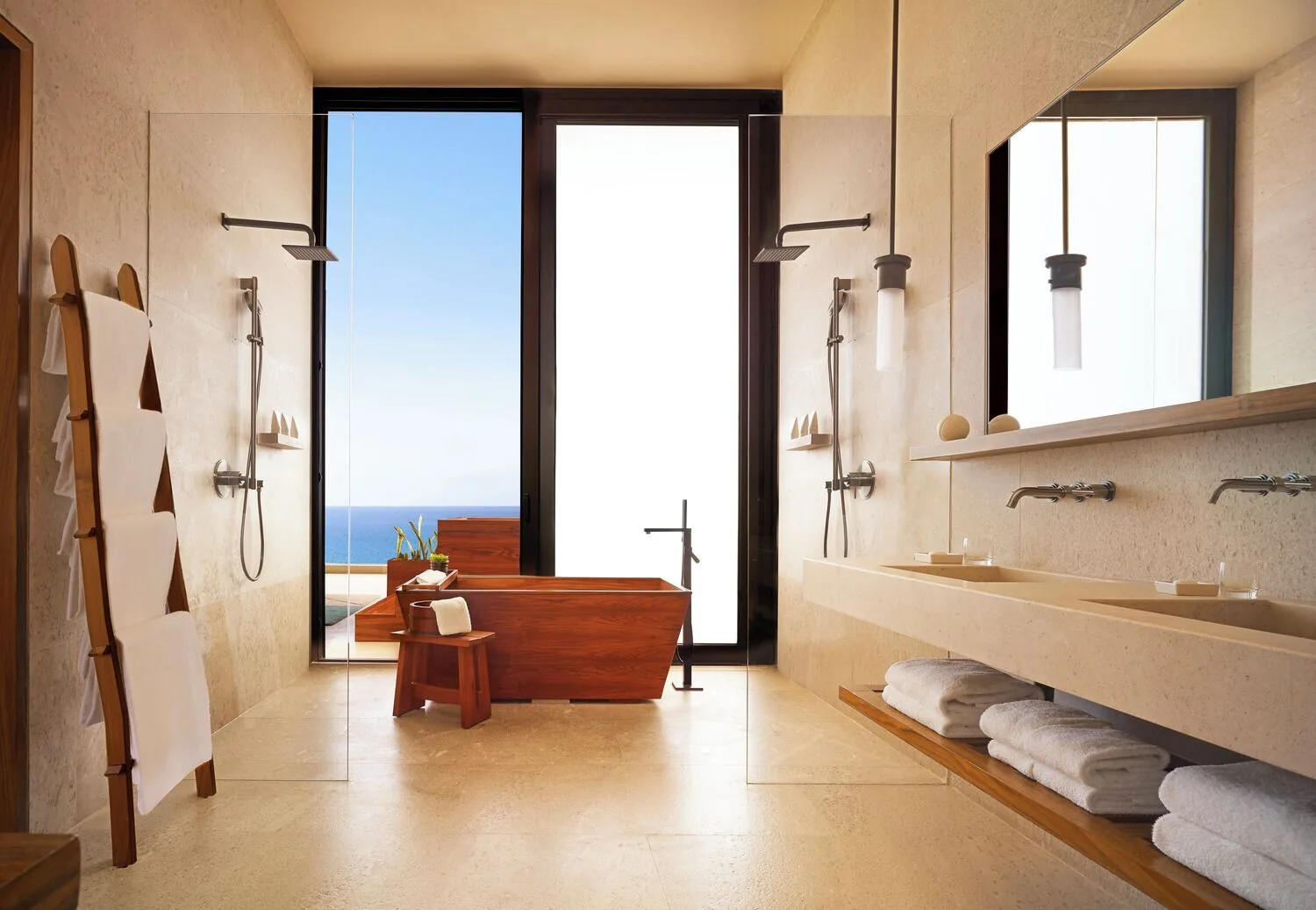 Oceanfront suite bathroom with soaking tub and ocean view at Nobu Hotel Los Cabos.