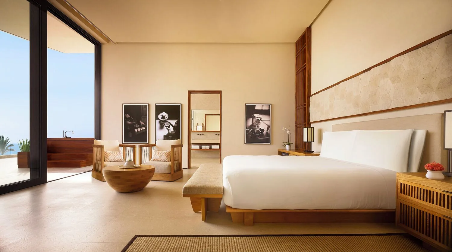Oceanfront suite bedroom with king bed and terrace at Nobu Hotel Los Cabos.