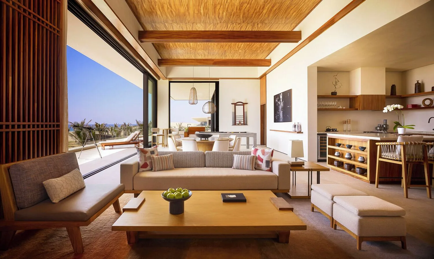 Oceanfront suite living room with terrace view at Nobu Hotel Los Cabos.