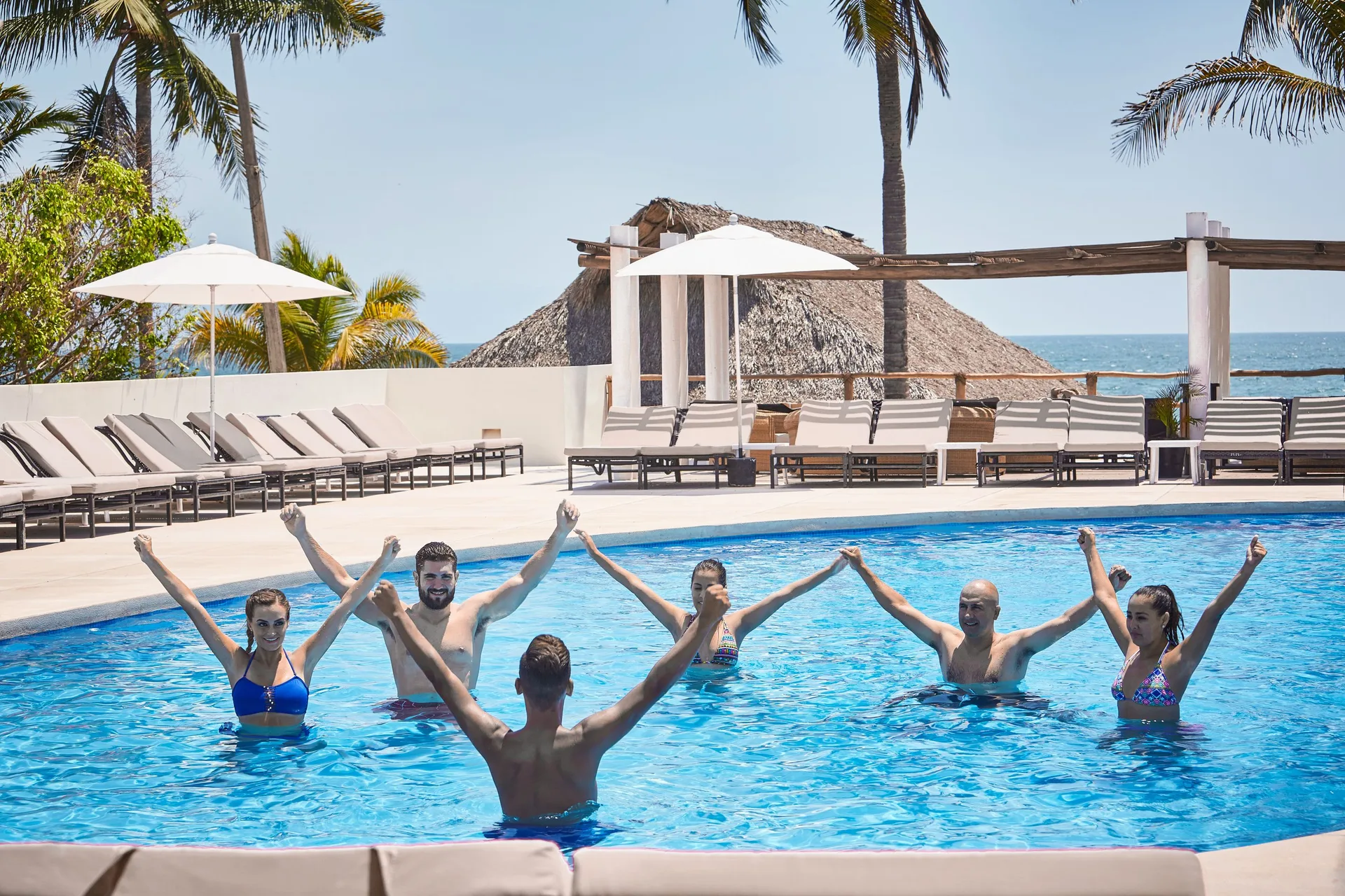 Guests join an aqua fitness class in the pool at Occidental Nuevo Vallarta.