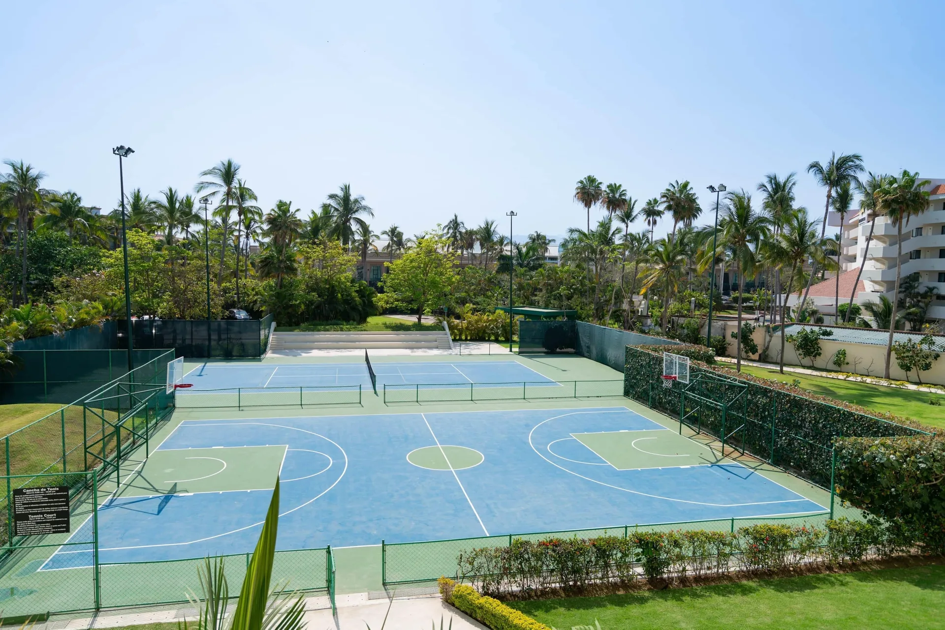 Outdoor tennis and basketball courts sit among palms at Occidental Nuevo Vallarta.