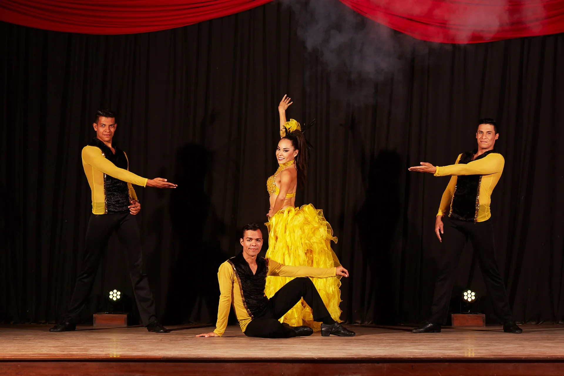 Dancers perform in yellow costumes onstage at Occidental Nuevo Vallarta.