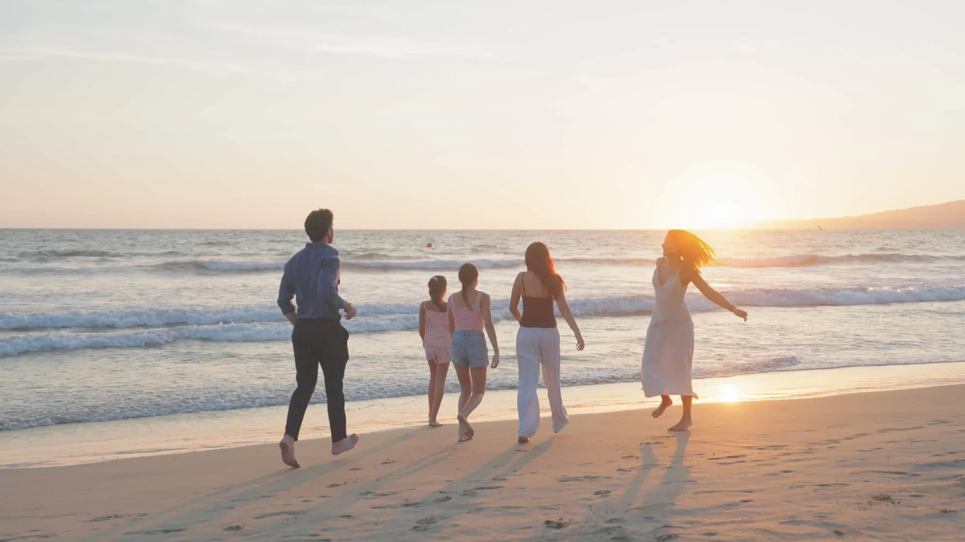 Guests walk along the shoreline at sunset near Occidental Nuevo Vallarta.