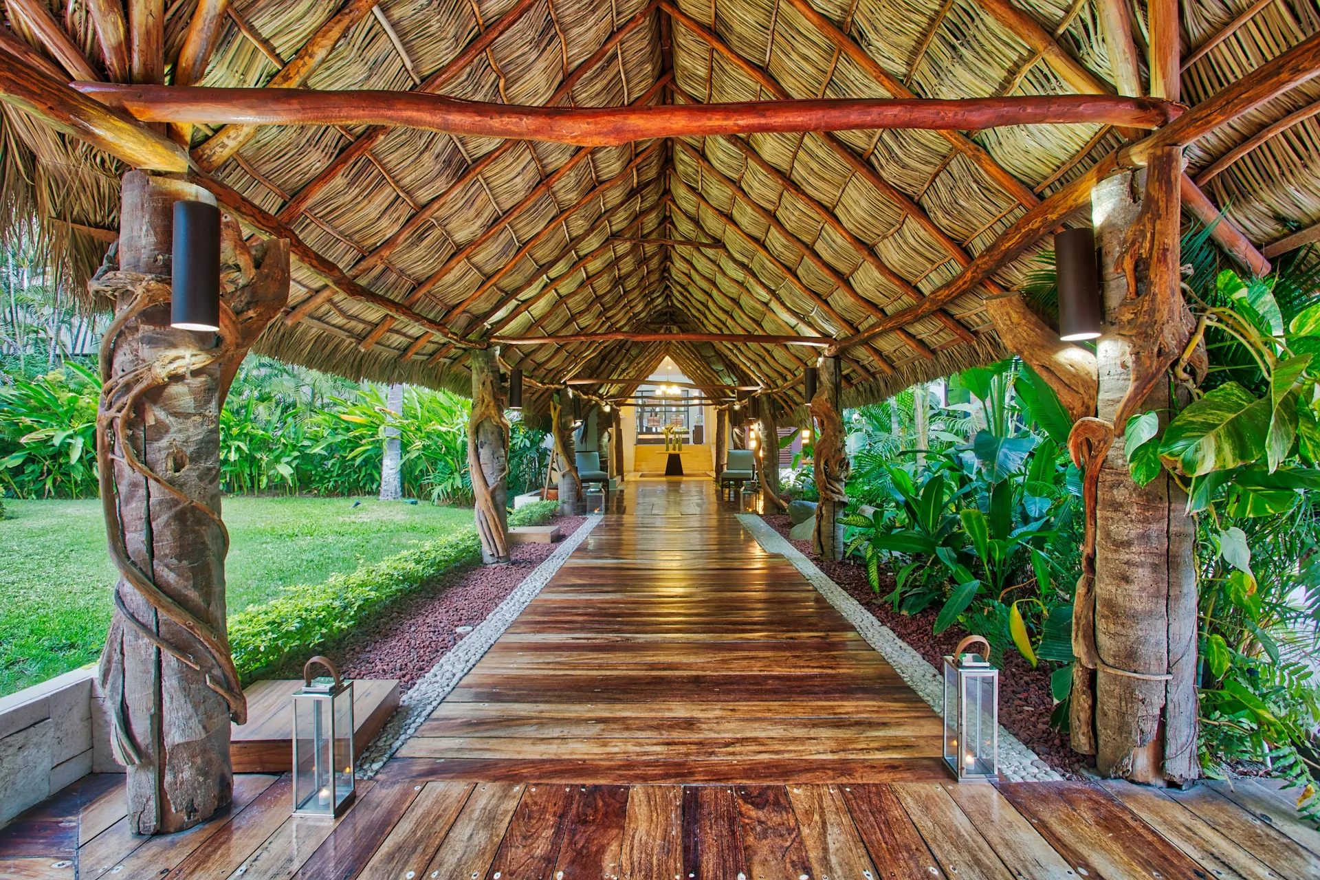 Thatched wooden walkway through tropical gardens at Occidental Nuevo Vallarta.
