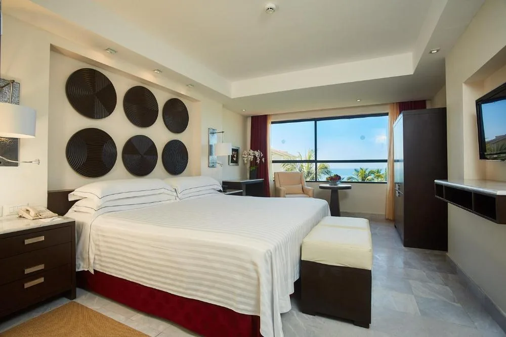 Deluxe Ocean View king room with large window at Occidental Nuevo Vallarta.