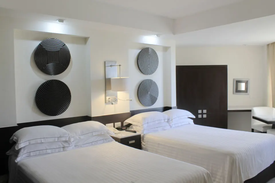 Deluxe Room with two beds and wall décor at Occidental Nuevo Vallarta.