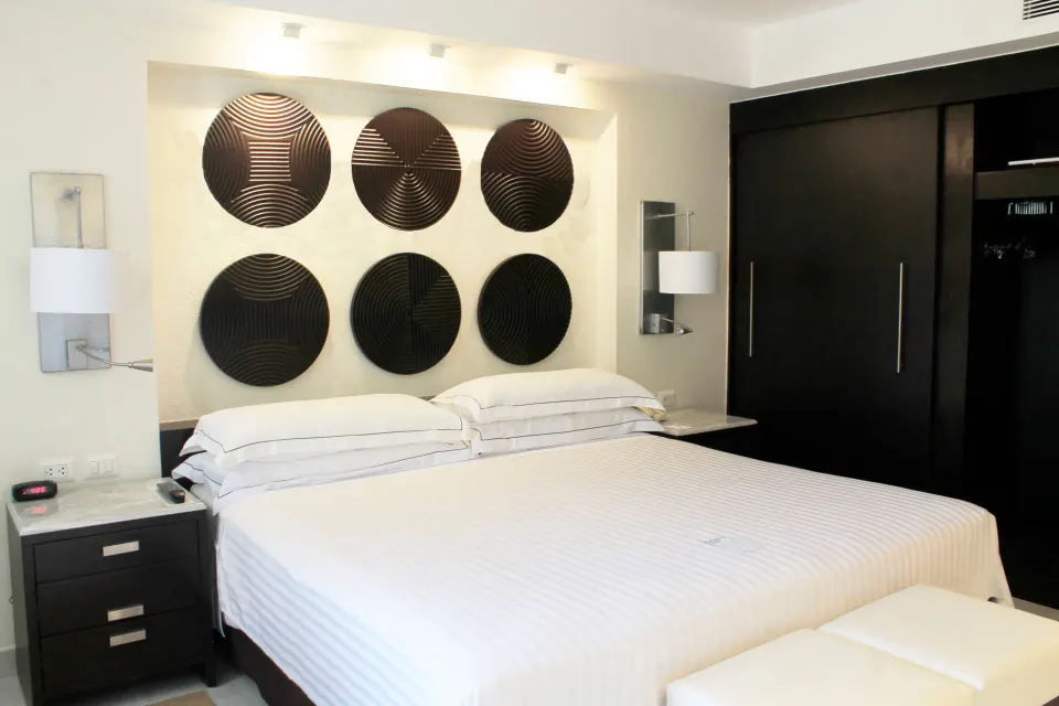 Royal Level luxury king room with circular wall art at Occidental Nuevo Vallarta.
