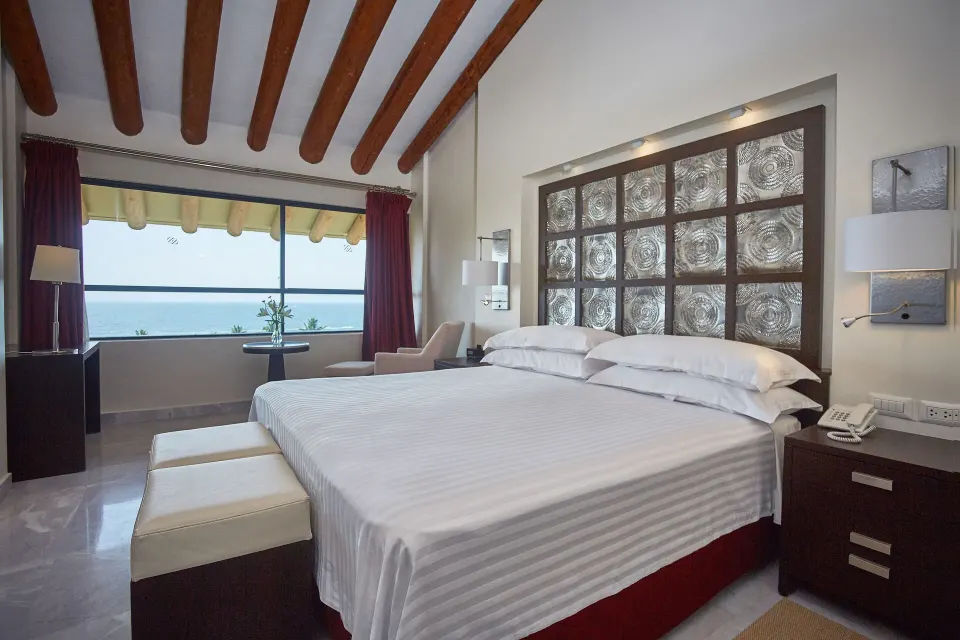 Royal Level luxury king room with ocean-facing window at Occidental Nuevo Vallarta.