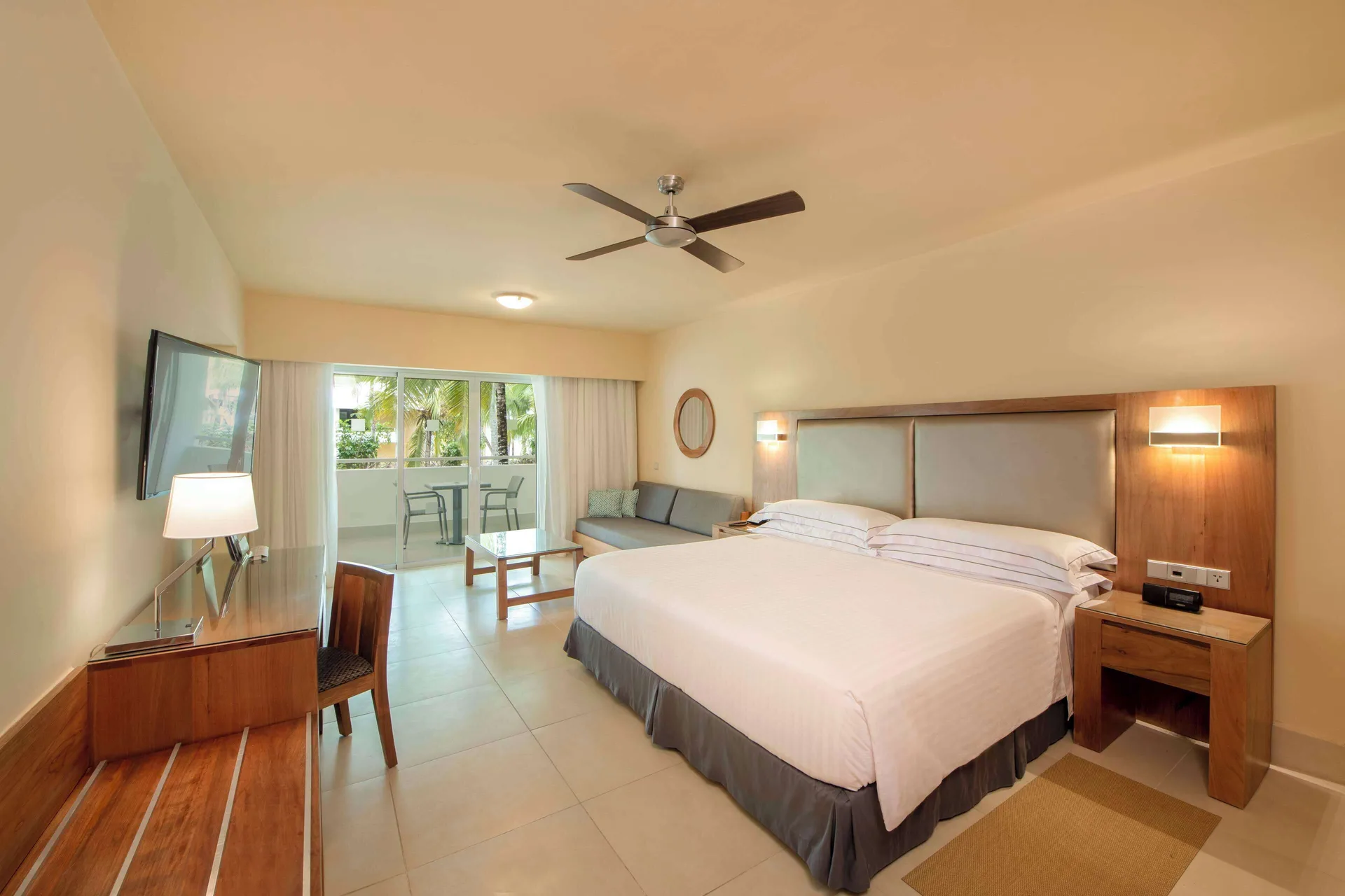 Superior Oceanfront king room with sofa and balcony at Occidental Punta Cana.