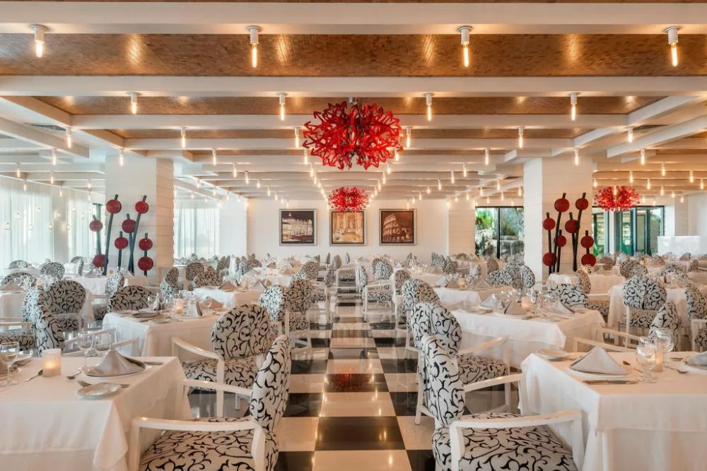 Elegant white dining room with patterned chairs at Ocean Coral and Turquesa.