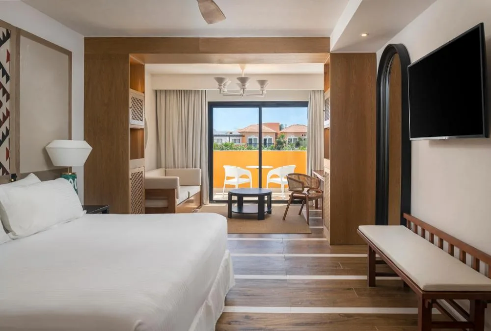 Junior Suite Elegance Nature View bedroom and balcony at Ocean Coral and Turquesa.