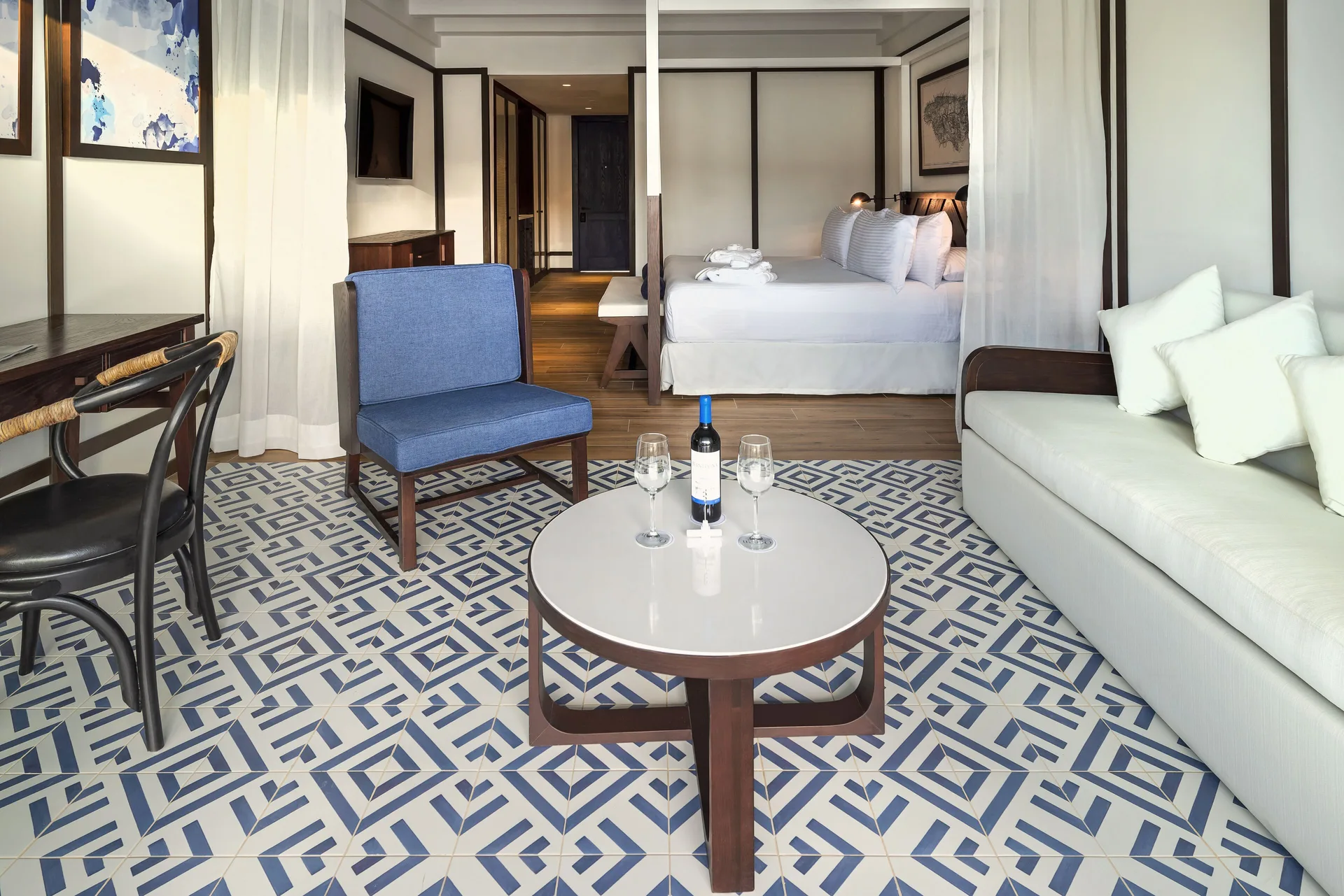Privilege Junior Suite Nature View sitting area with bed beyond at Ocean Coral Spring.