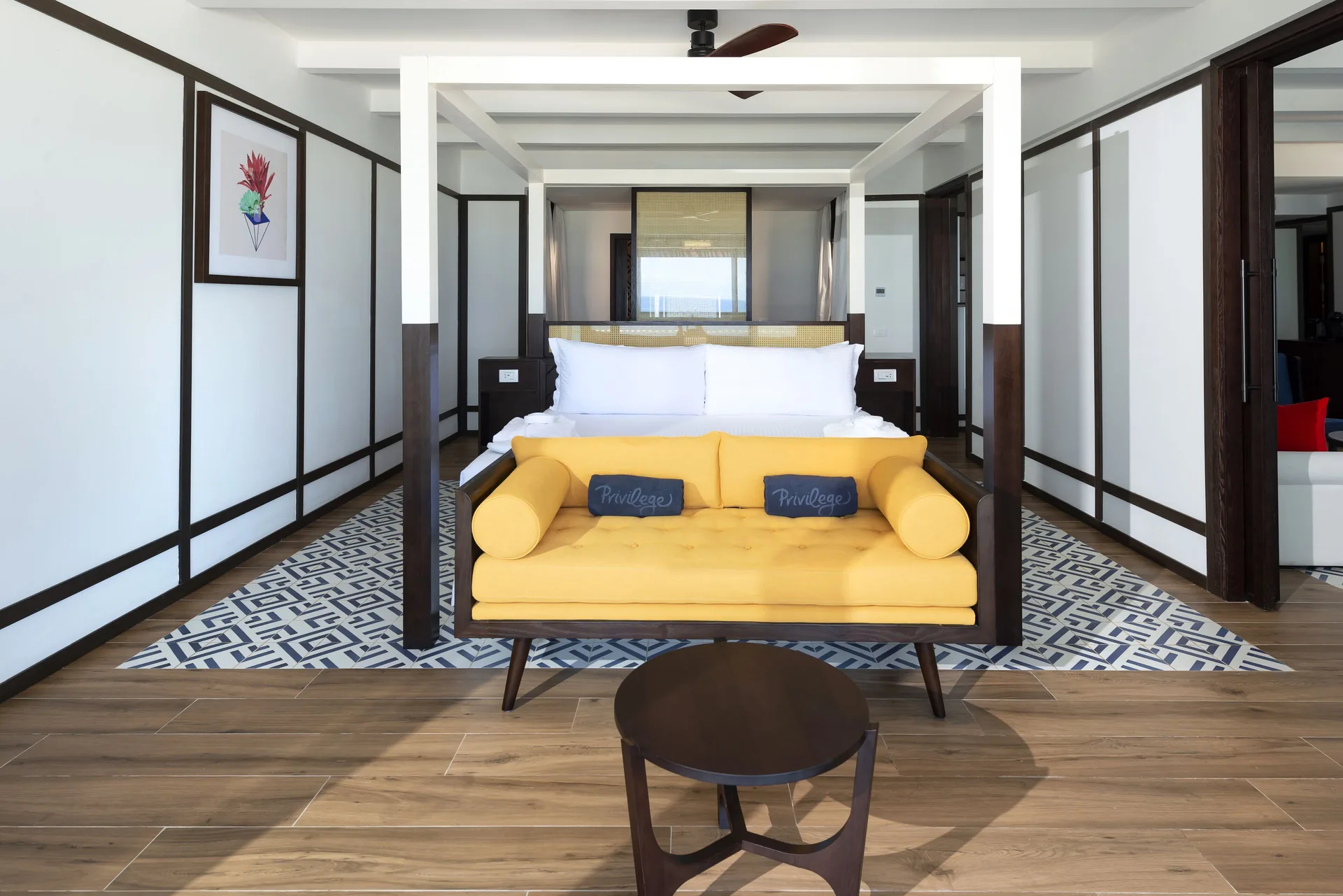 Privilege Master Suite king bed with yellow sofa at Ocean Coral Spring.
