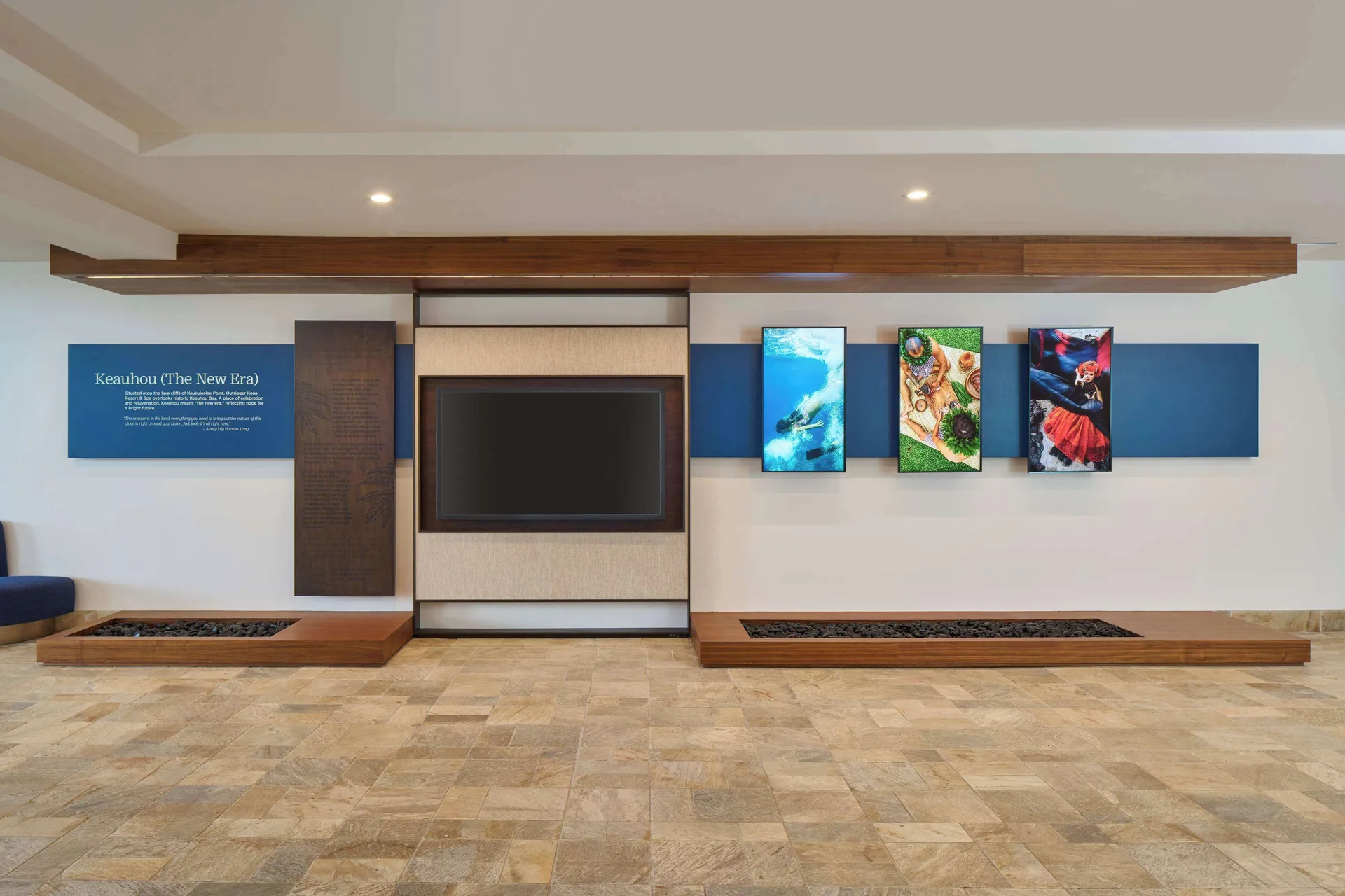 Cultural display wall with screens and artwork in the lobby at Outrigger Kona Resort and Spa.
