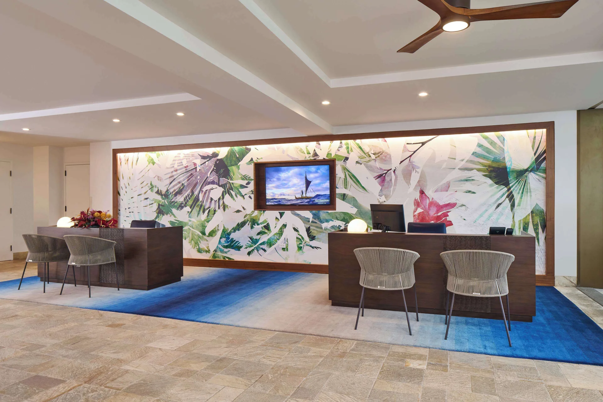 Front desk area with tropical wall art at Outrigger Kona Resort and Spa.