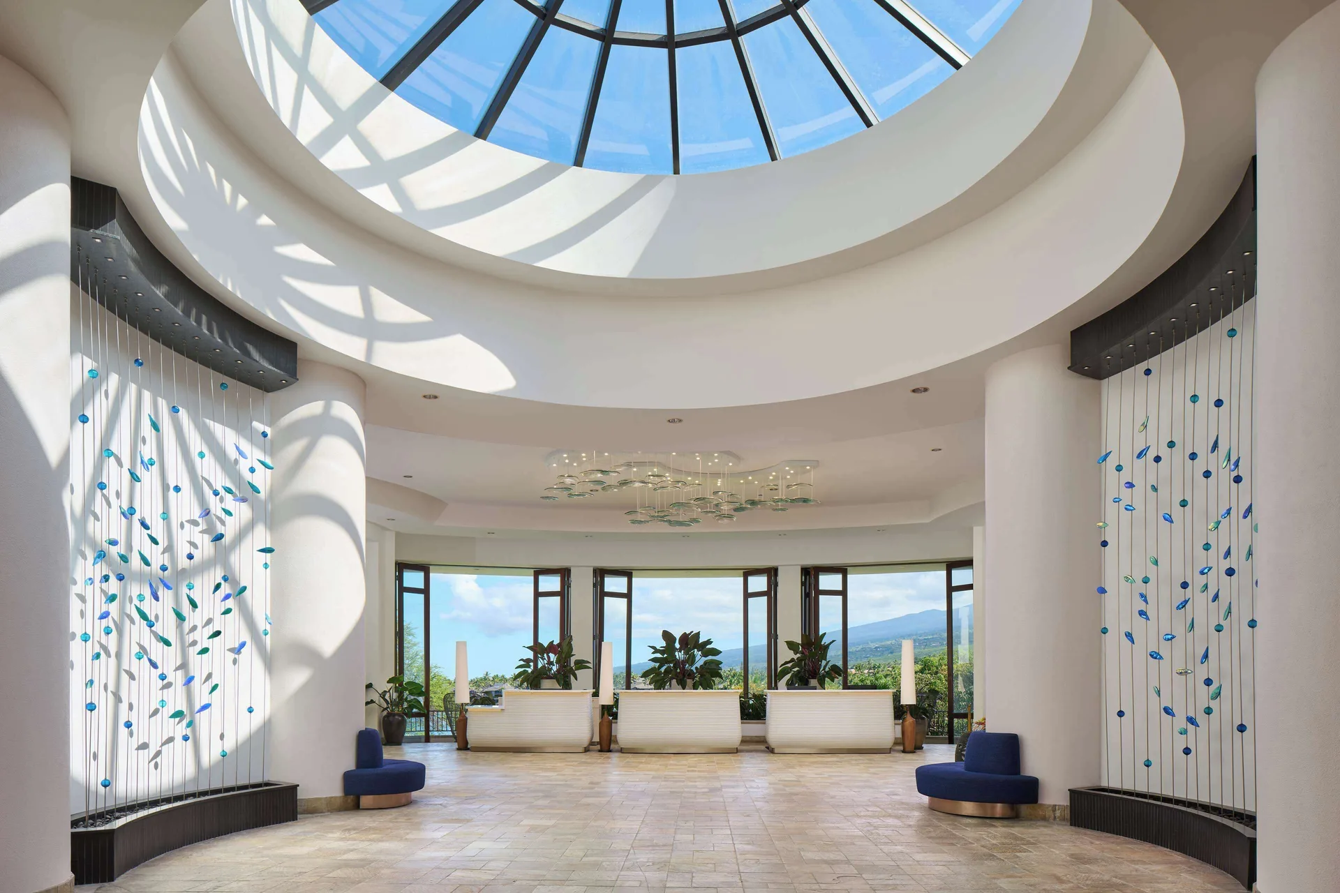 Bright lobby rotunda with skylight and ocean-facing windows at Outrigger Kona Resort and Spa.
