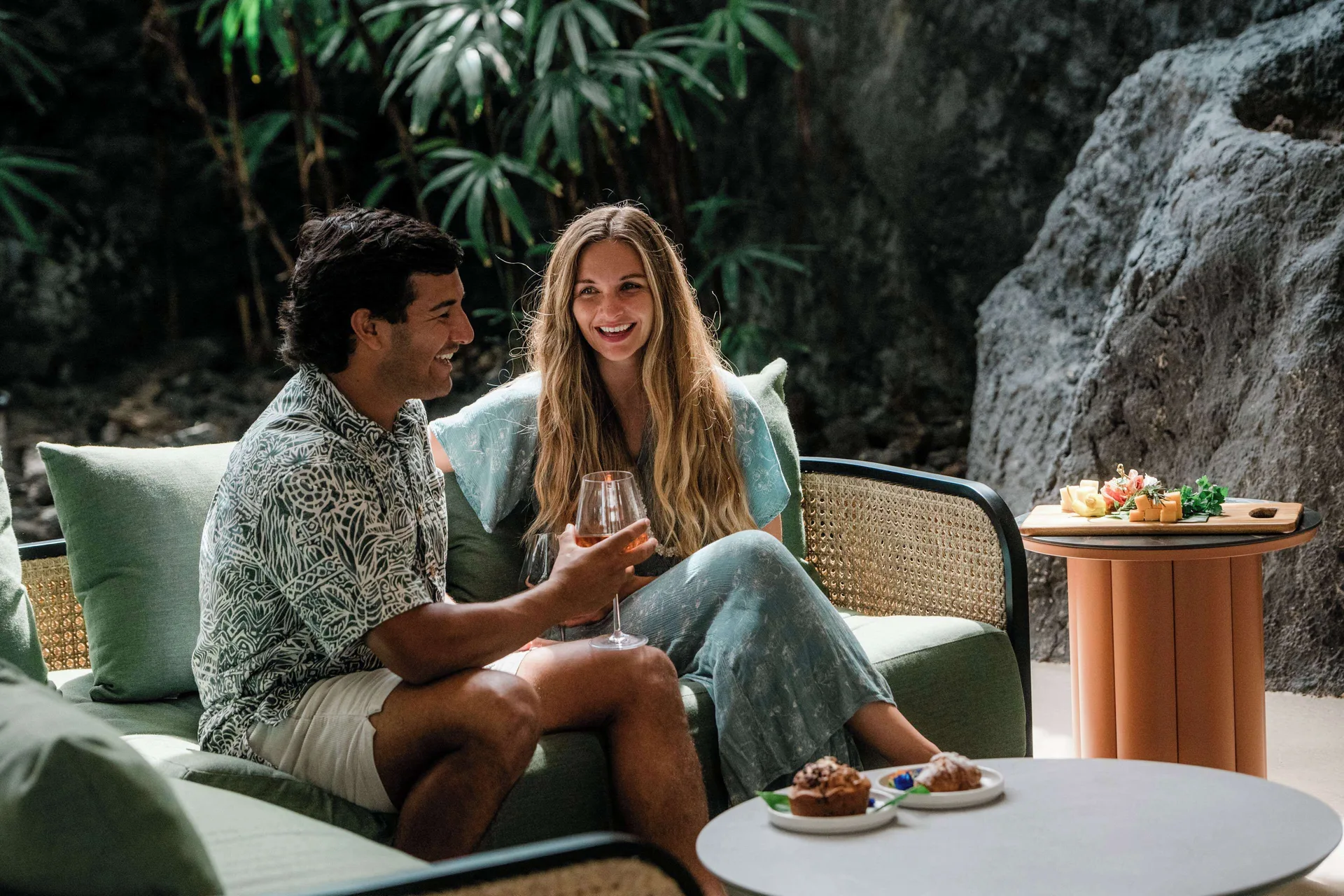 Guests seated with drinks and small plates at Outrigger Kona Resort and Spa.