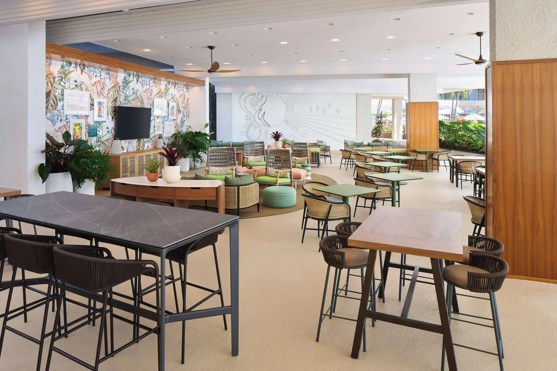 Lounge-style dining area with tables and tropical décor at Outrigger Kona Resort and Spa.