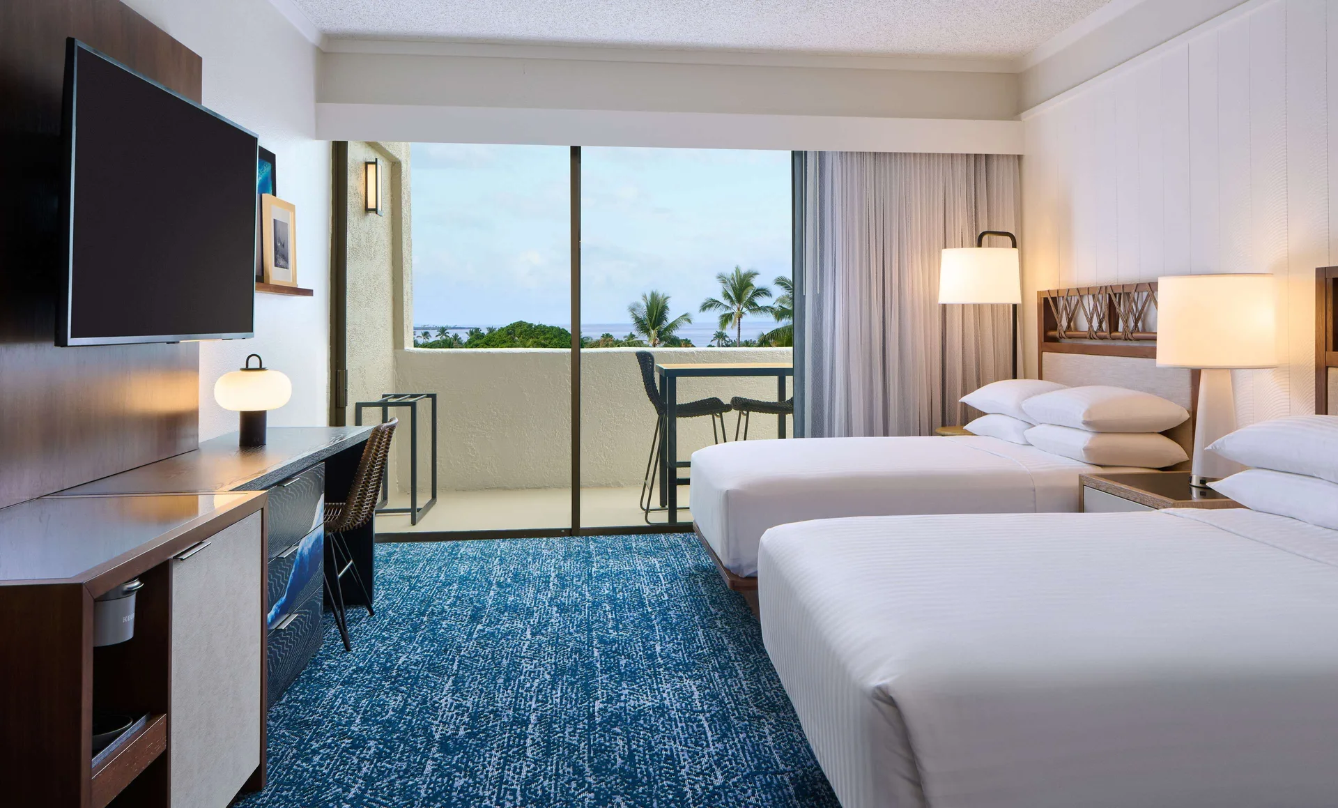 Oceanfront club suite bedroom with two beds and balcony at Outrigger Kona Resort and Spa.