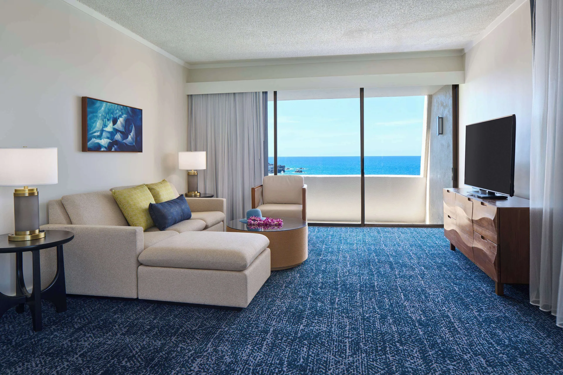 Oceanfront club suite living area with sofa bed and TV at Outrigger Kona Resort and Spa.