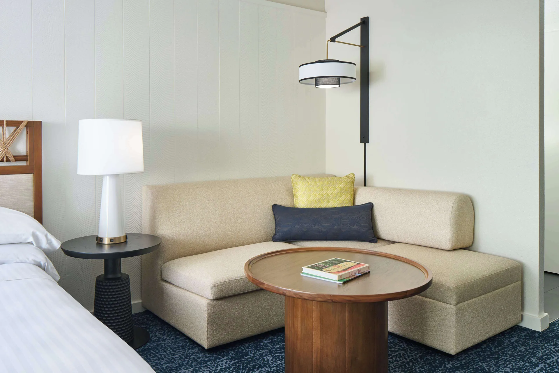 Sofa seating area beside the bed in an oceanfront room at Outrigger Kona Resort and Spa.
