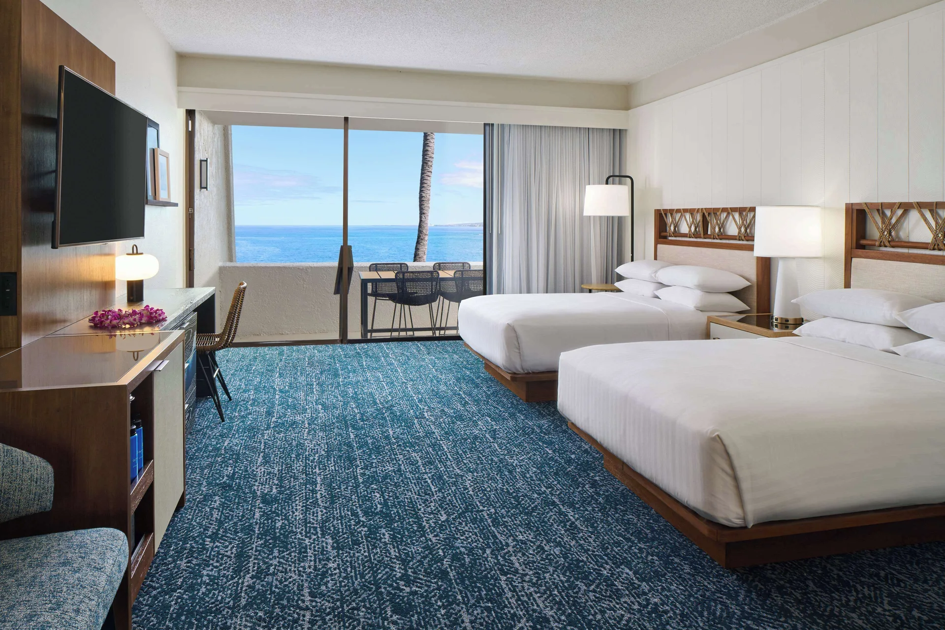 Oceanfront room with two beds and balcony view at Outrigger Kona Resort and Spa.