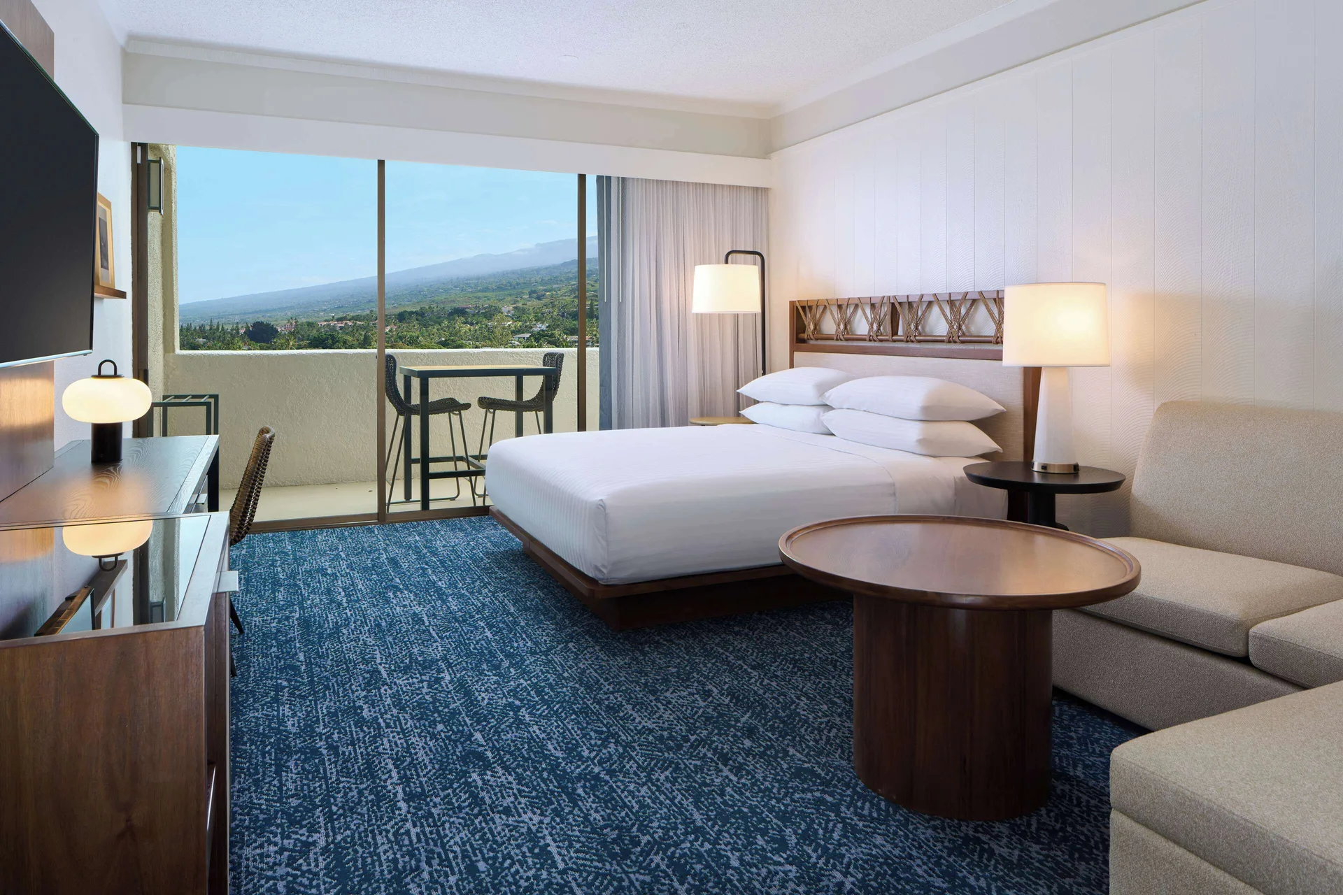 King bed resort view room with sofa and balcony at Outrigger Kona Resort and Spa.
