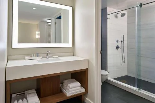 Suite bathroom sink and glass shower at Outrigger Kona Resort and Spa.