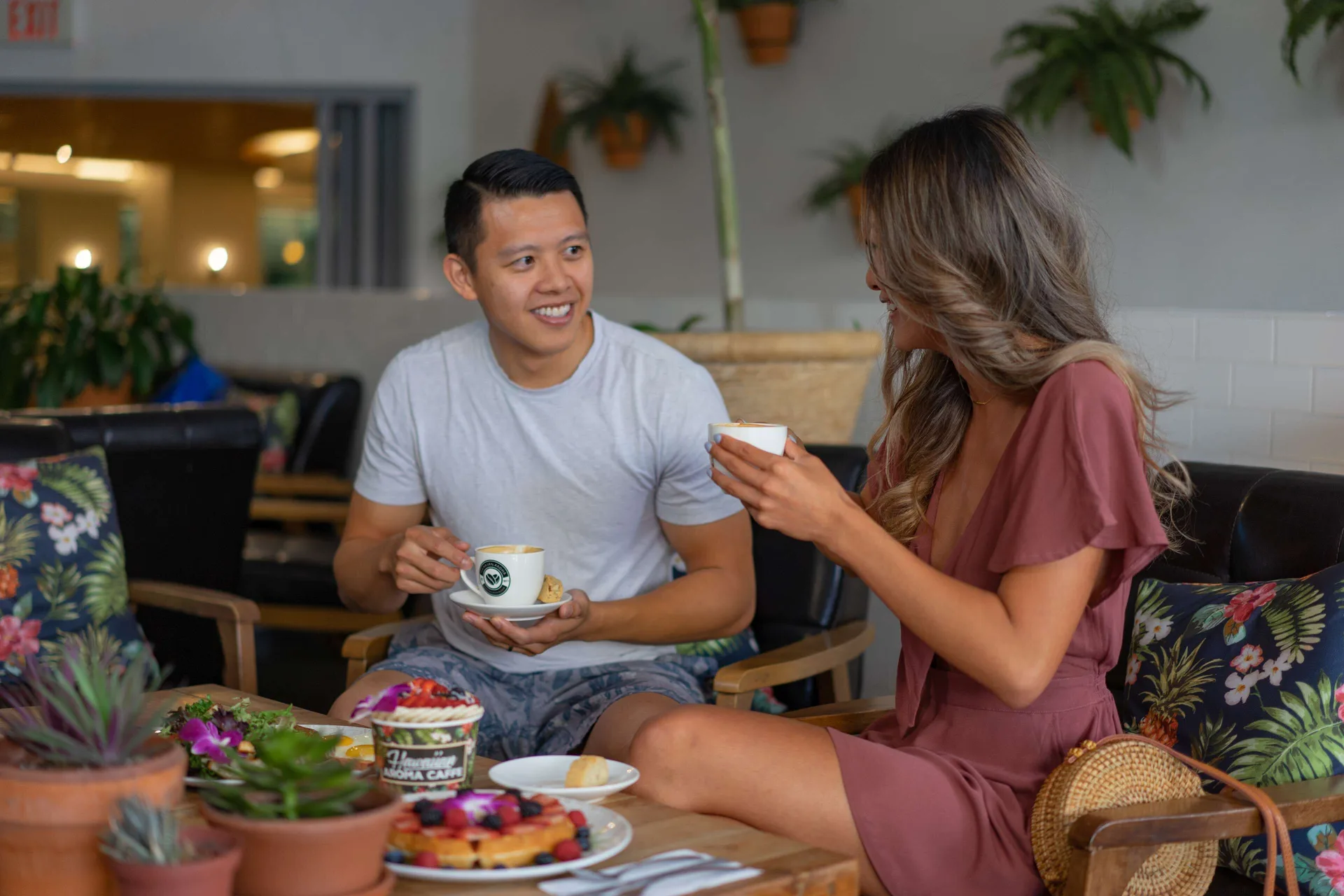 Two guests enjoy coffee and pastries in Hawaiian Aroma Caffé at OUTRIGGER Waikiki Beachcomber Hotel.