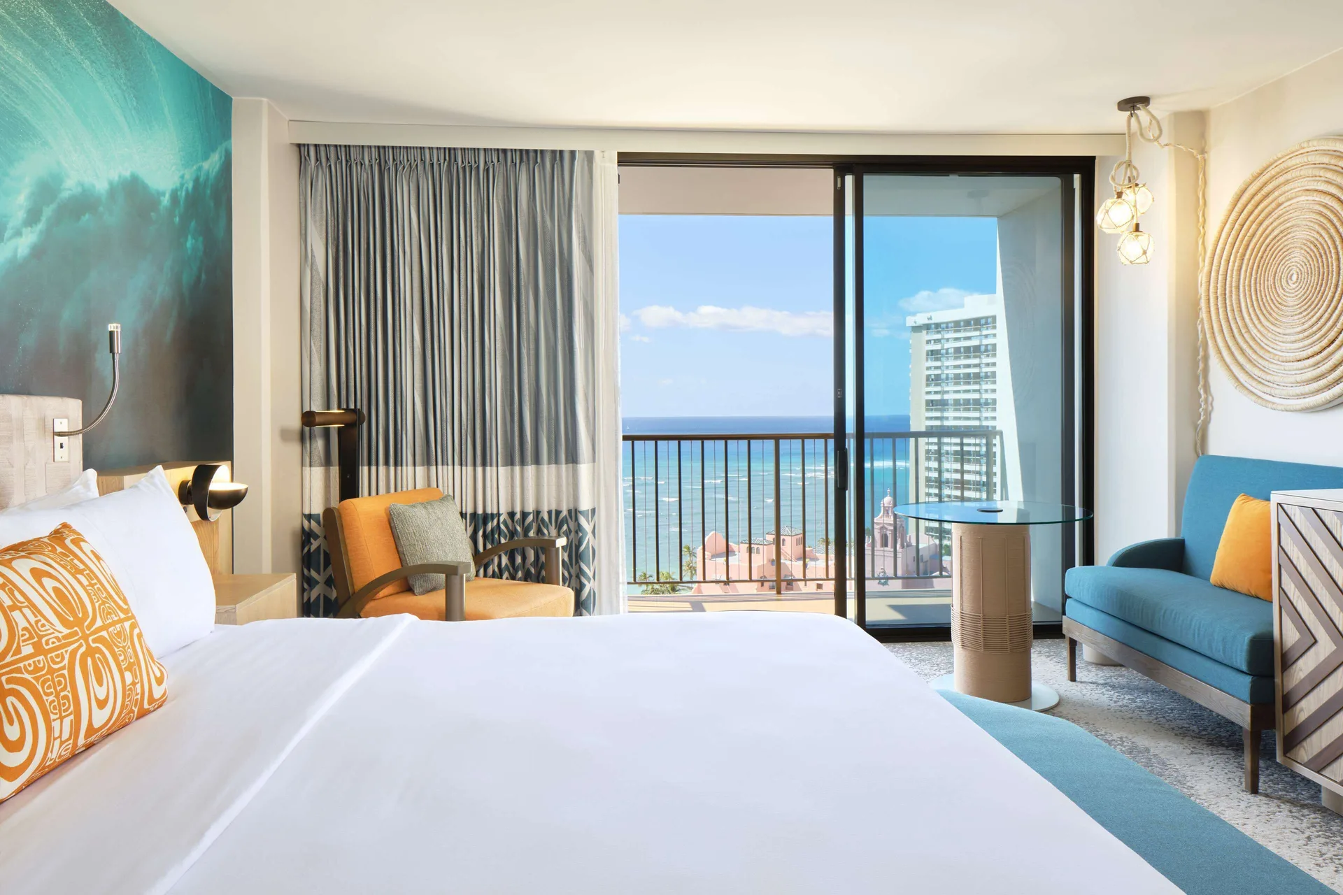King bed room seating area and ocean balcony at OUTRIGGER Waikiki Beachcomber Hotel.