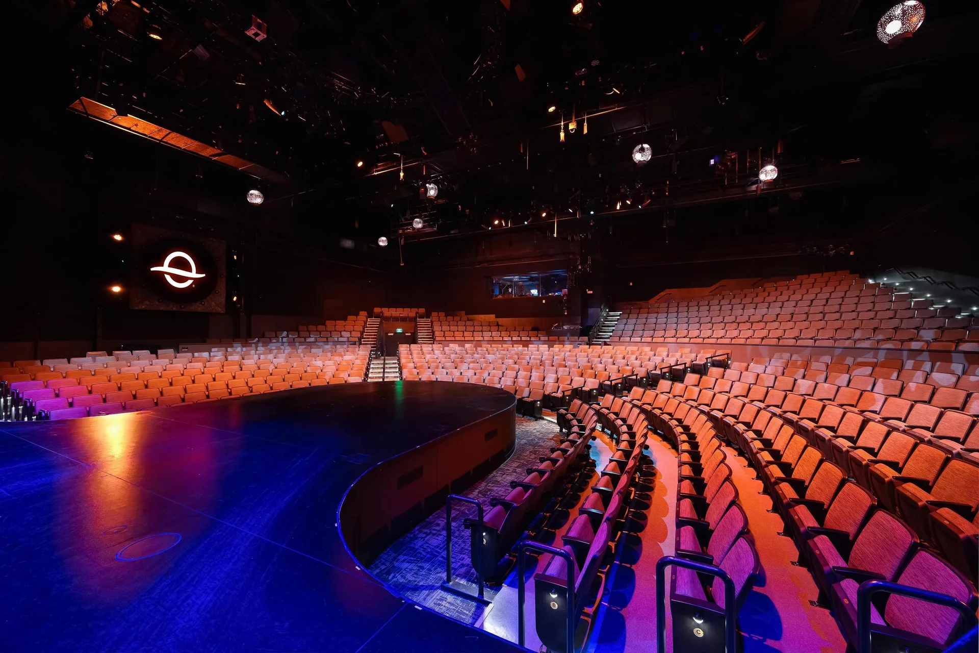 Curved theater stage and rows of seats at OUTRIGGER Waikiki Beachcomber Hotel.