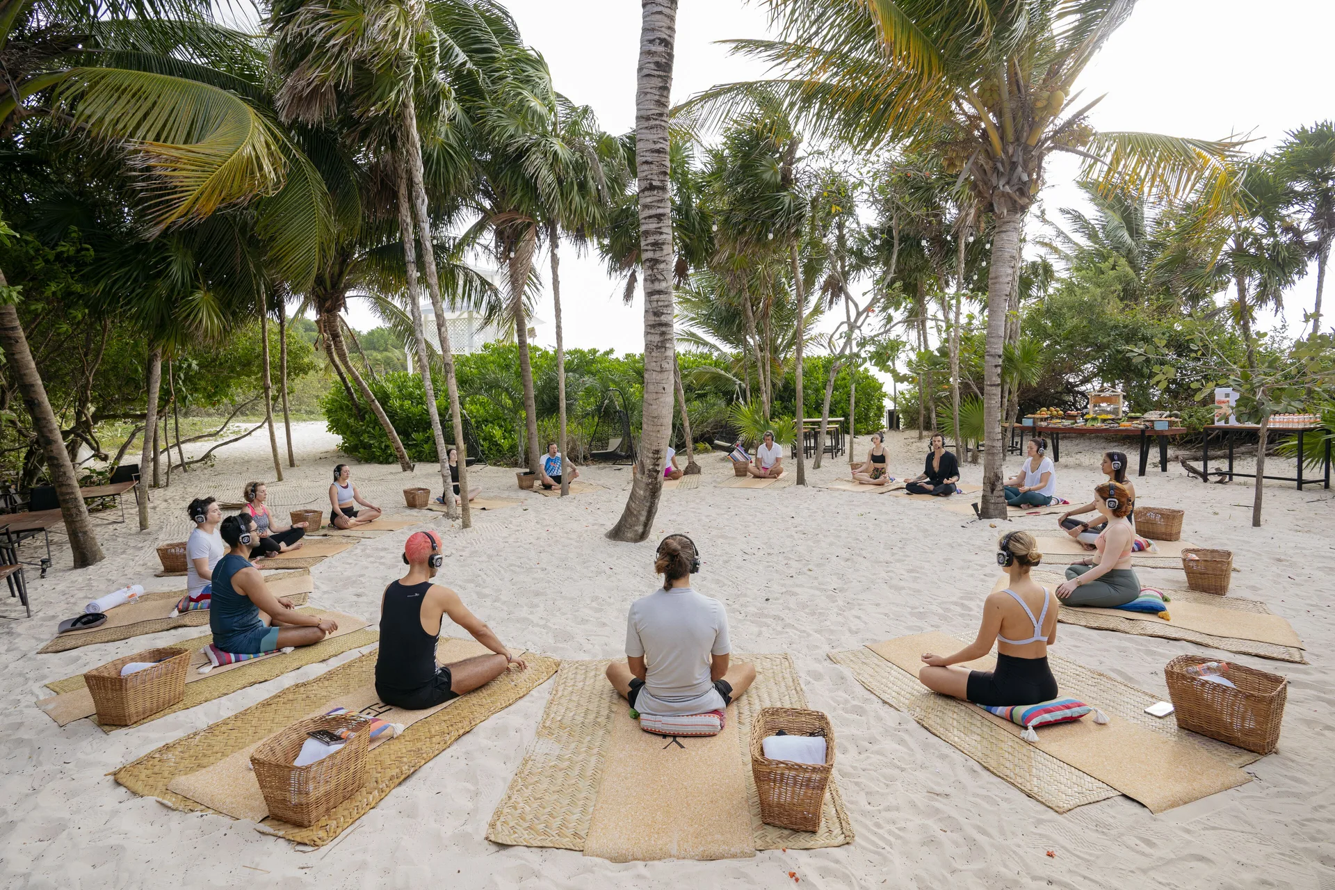 A beach yoga circle sits among palms at Paradisus La Perla Riviera Maya.