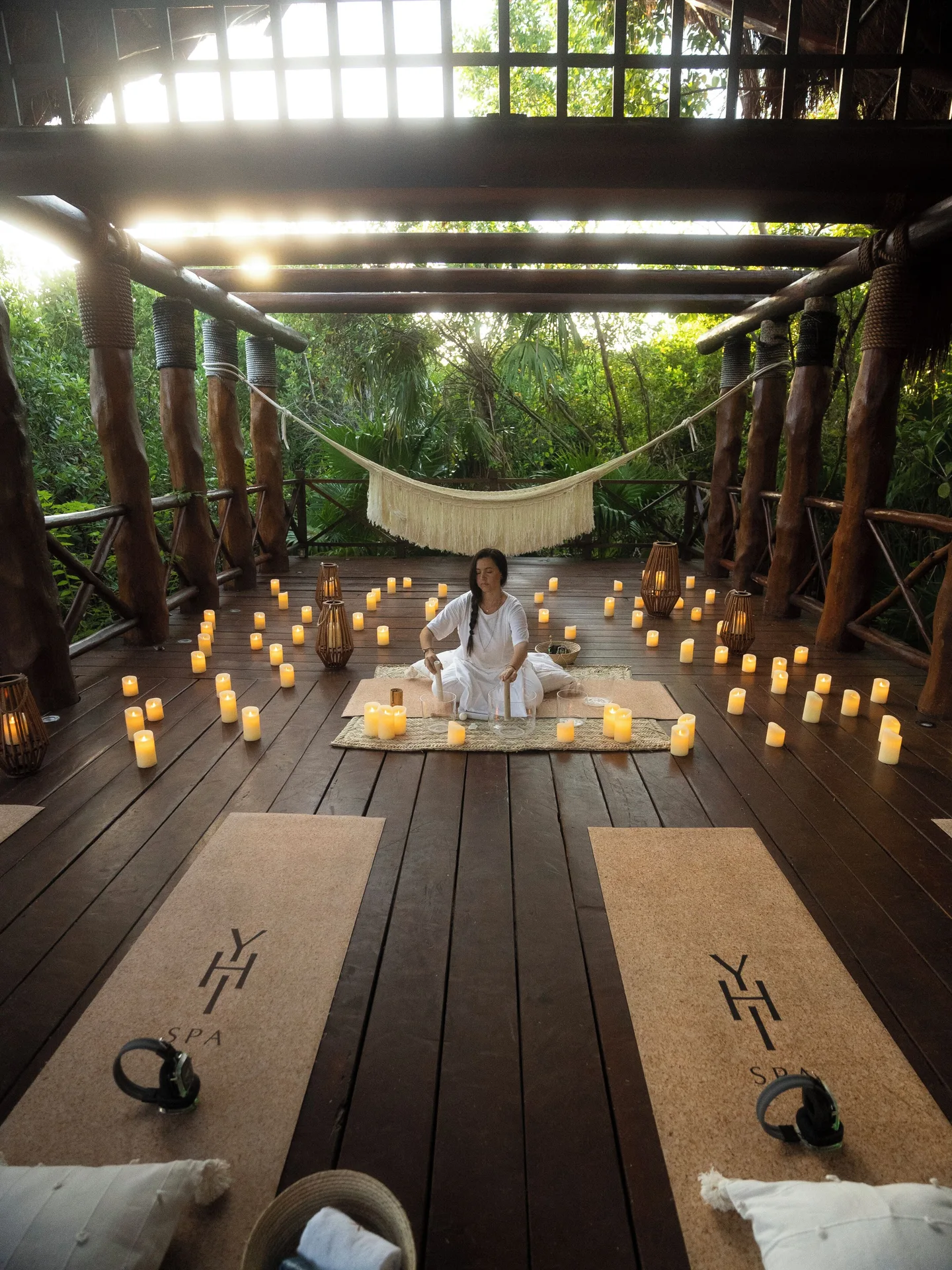 Candlelit wellness setup on a wooden deck at Paradisus La Perla Riviera Maya.