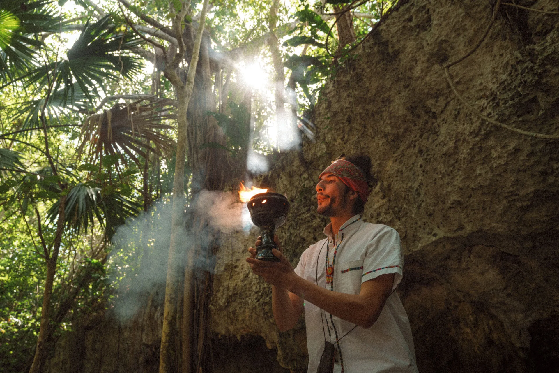 A ceremonial flame is held in the jungle at Paradisus La Perla Riviera Maya.