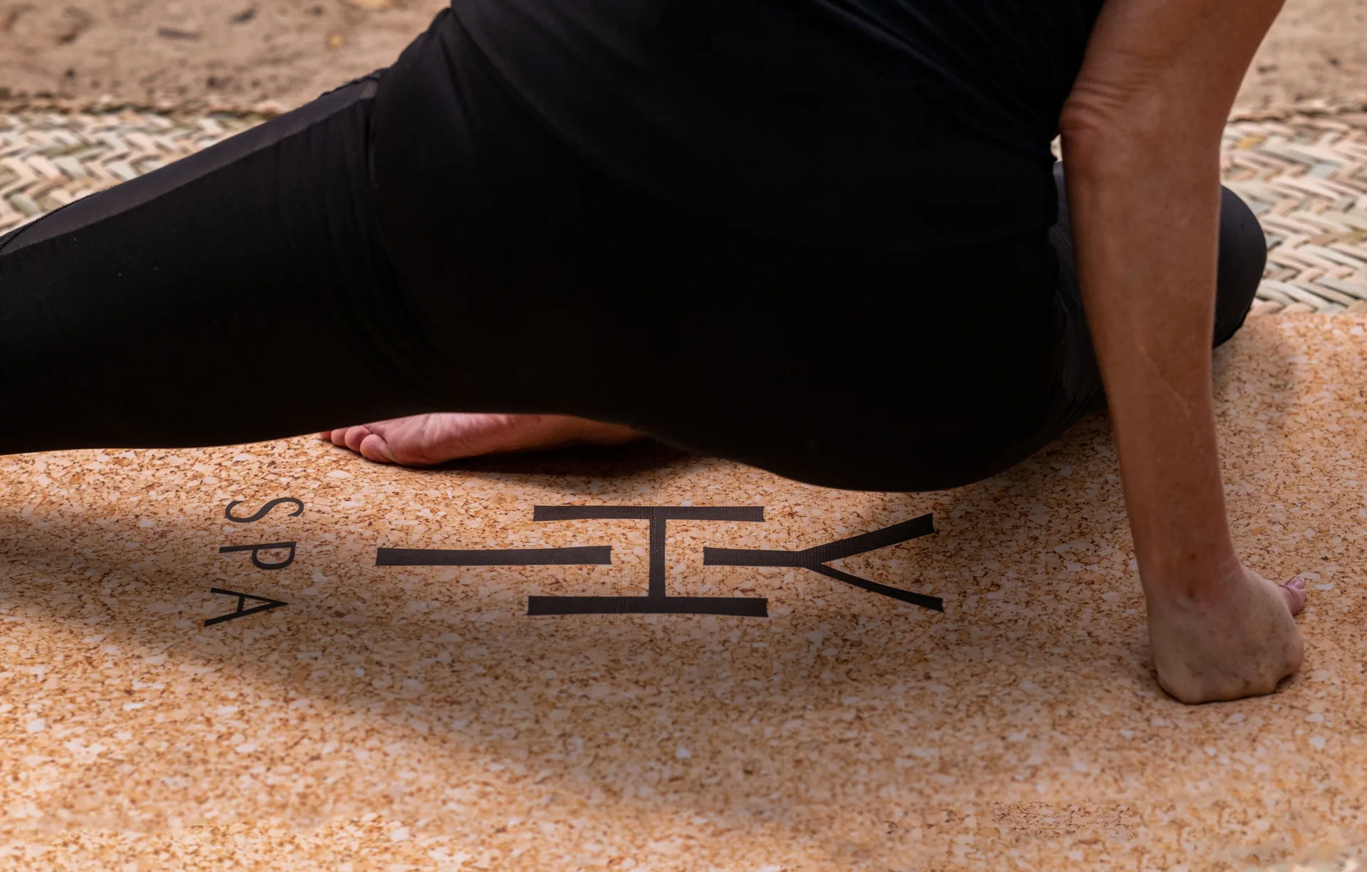 A guest stretches on a spa mat during a wellness session at Paradisus La Perla Riviera Maya.