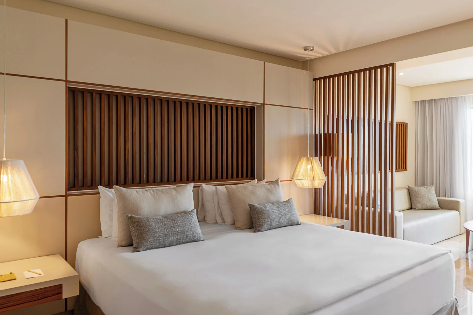 Junior Suite Nature View king bed and sitting area at Paradisus La Perla Riviera Maya.