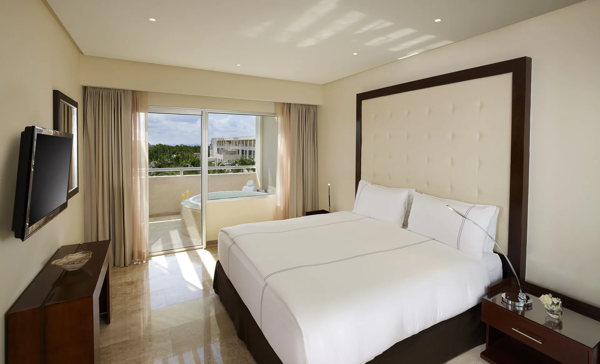 Master Suite Nature View bedroom with king bed and balcony at Paradisus La Perla Riviera Maya.