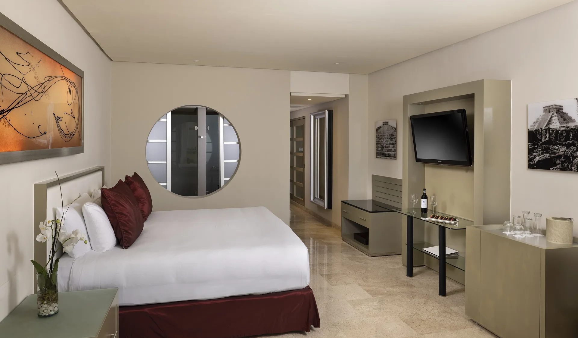 King bed guest room with wall-mounted TV at Paradisus La Perla Riviera Maya.
