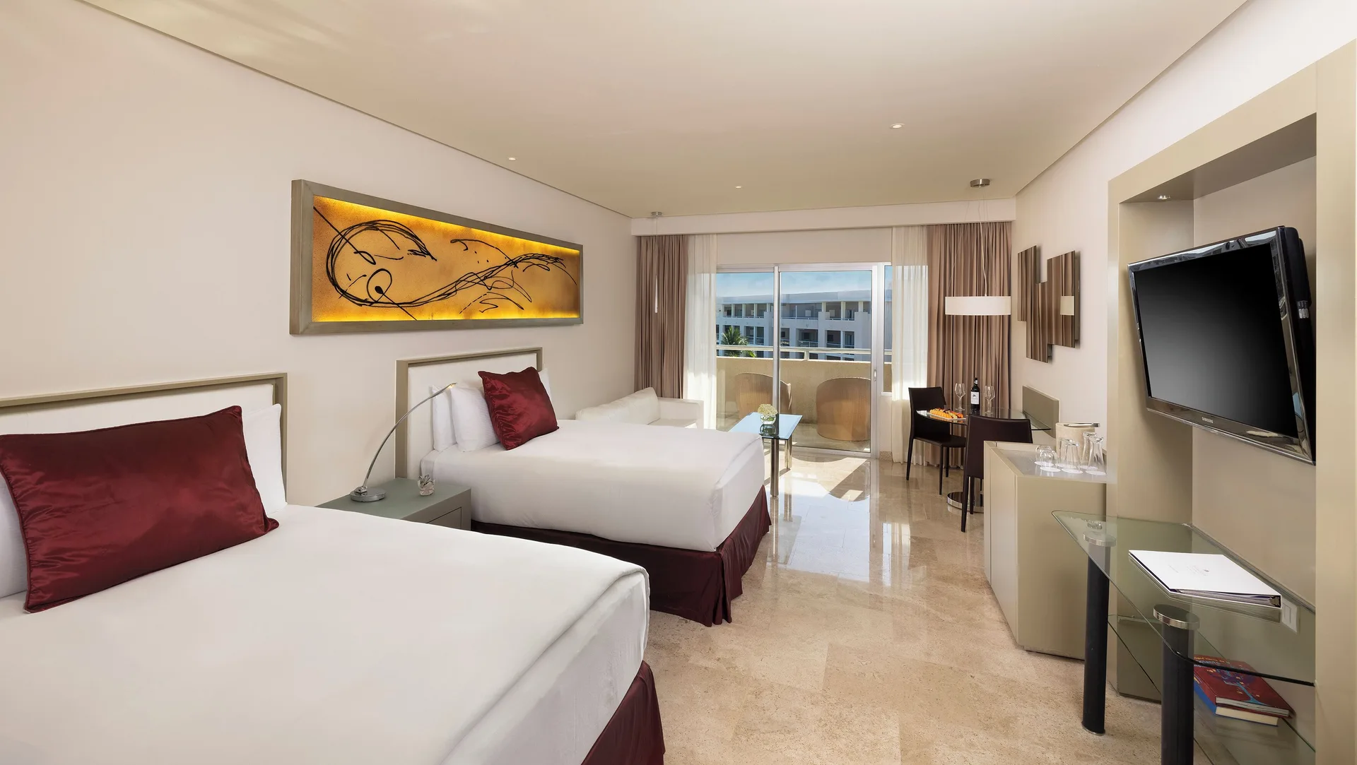 Two-bed guest room with balcony doors and TV at Paradisus La Perla Riviera Maya.