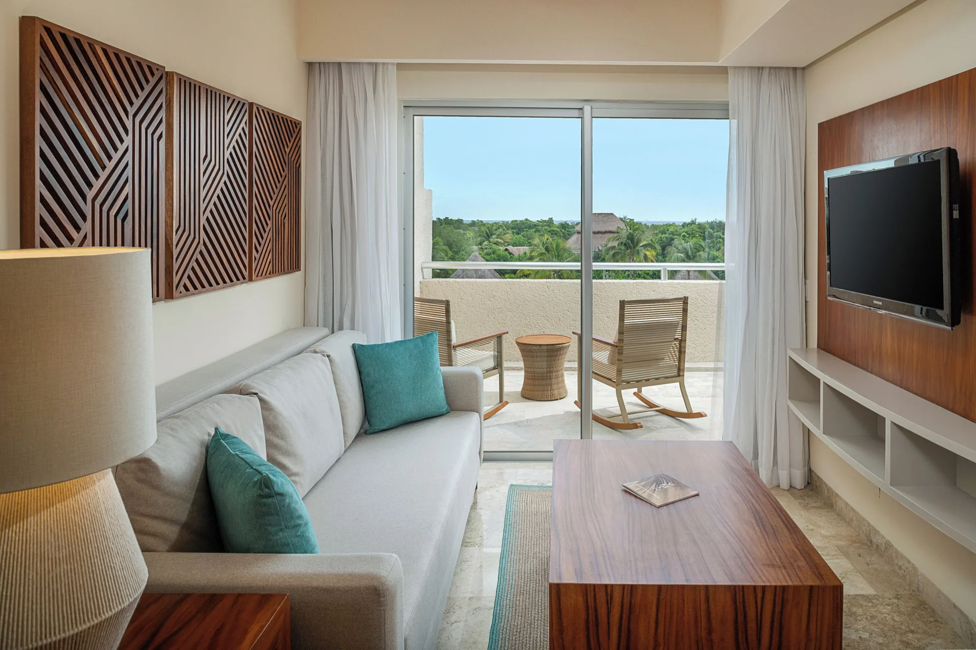 Suite Nature View living area with sofa and balcony seating at Paradisus La Perla Riviera Maya.