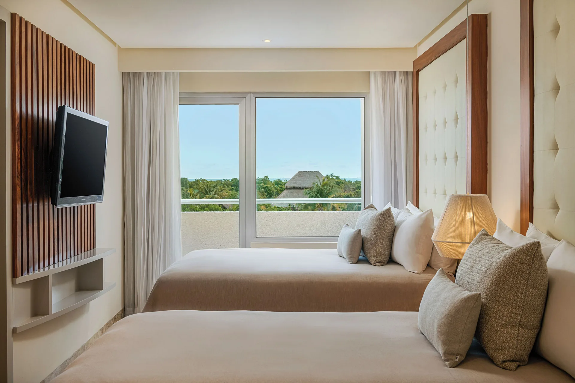 Suite Nature View bedroom with two beds and balcony greenery at Paradisus La Perla Riviera Maya.